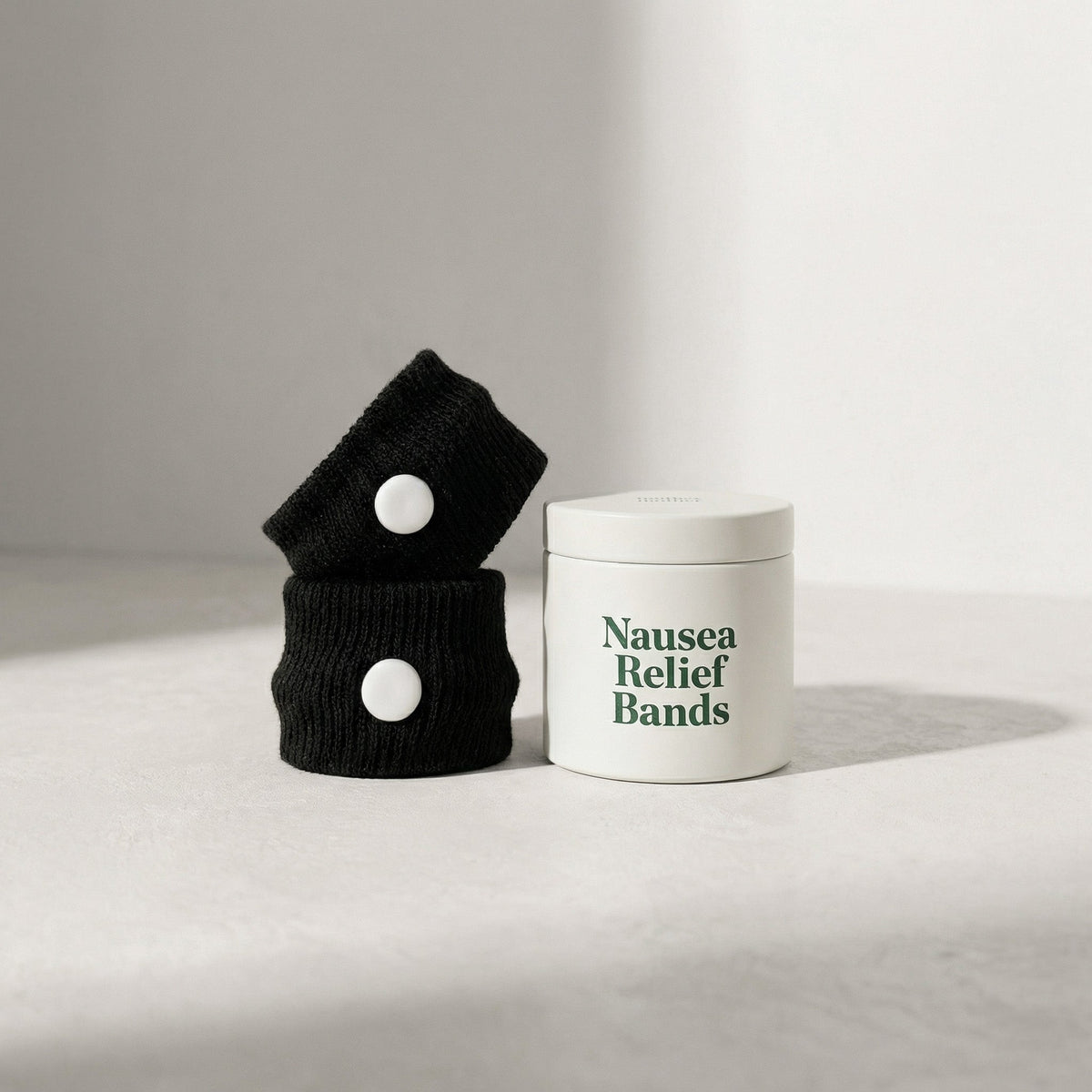 nausea bands next to a white tin