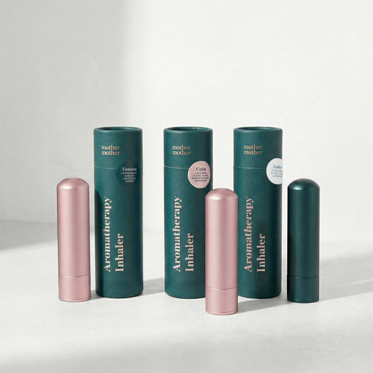 Four mother mother Aromatherapy Inhaler products arranged on a light gray surface against a white background.