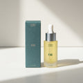 Bottle of 'mother mother' oil with dropper and packaging on a light background